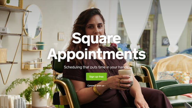 Square apointment scheduling app with an image of a woman sitting in a chair drinking a cup of coffee